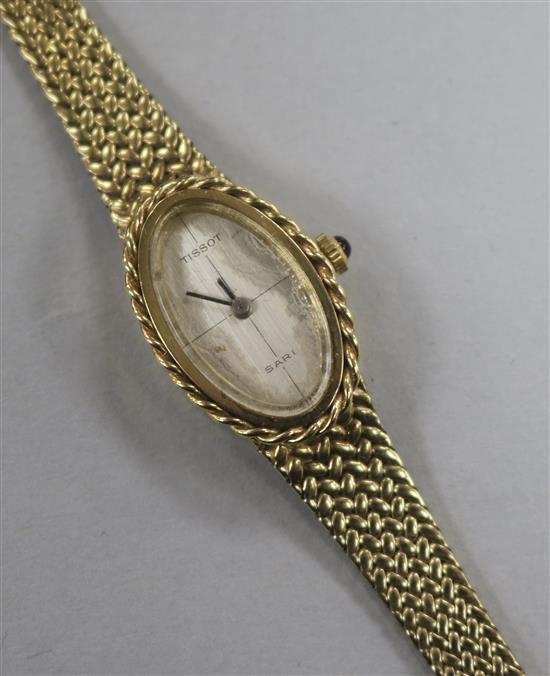 A ladies 9K gold (375) Tissot Sari wristwatch on woven bracelet, with oval silvered dial